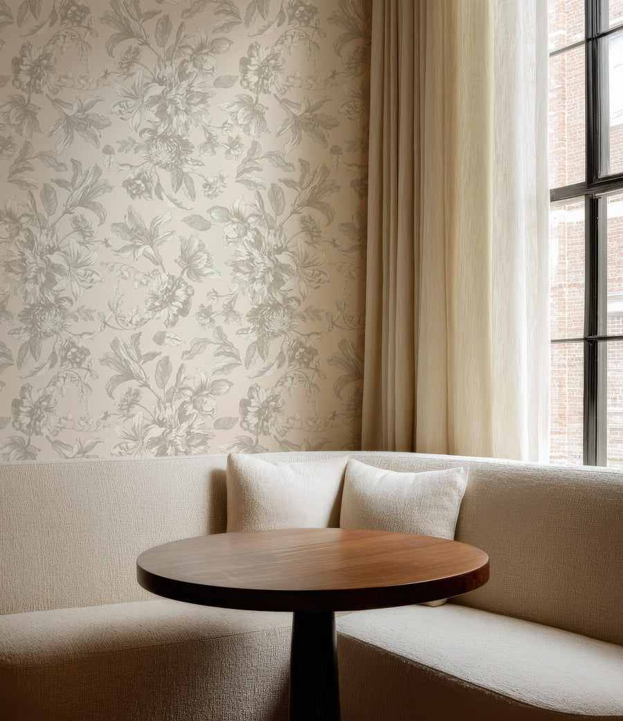 Beige sofa with a wooden table against a Neutral Vintage Floral Wallpaper – Gentle Taupe Botanical Pattern and a window with white curtains.