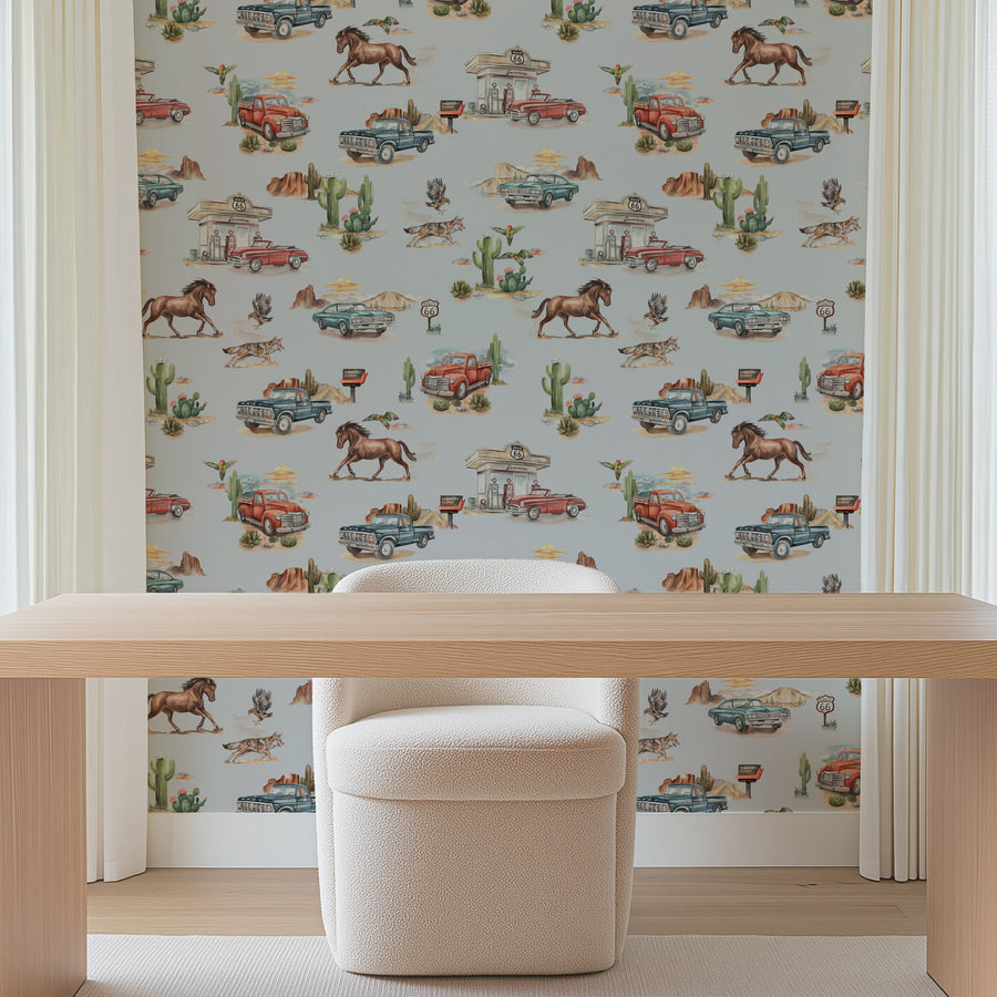 Blue Western cowboy-themed wallpaper in a room with a wooden desk and chair.