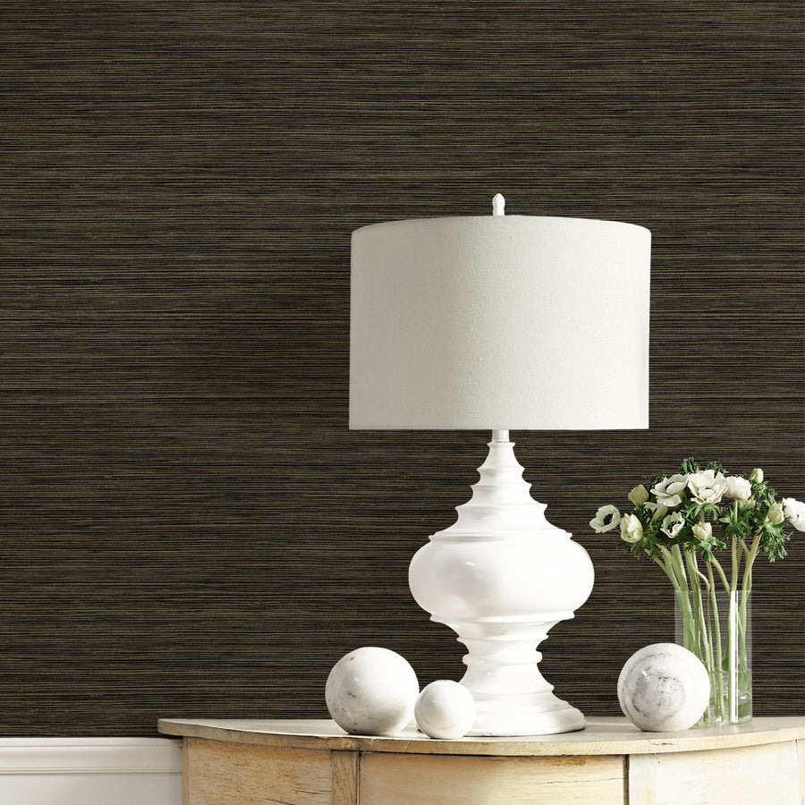 White table lamp on a wooden surface with dark textured wall in the background