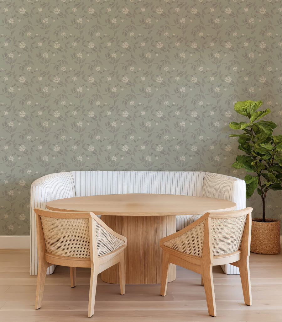 Dining area with Blythe wallpaper in sage green featuring a trailing floral vine pattern in soft cream and taupe