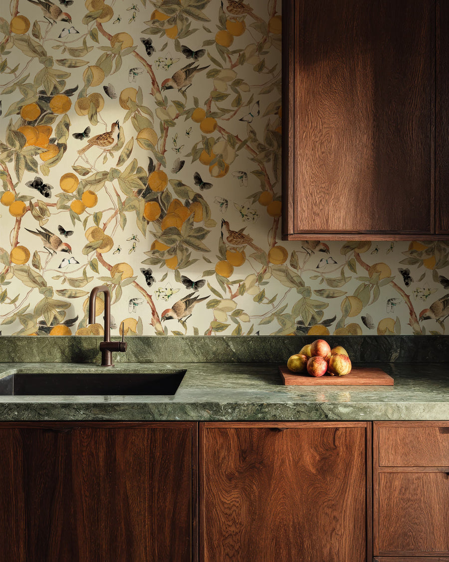 Kitchen with wooden cabinets, green marble countertop, and Vintage Citrus Wallpaper – Orange Tree, Birds & Butterflies