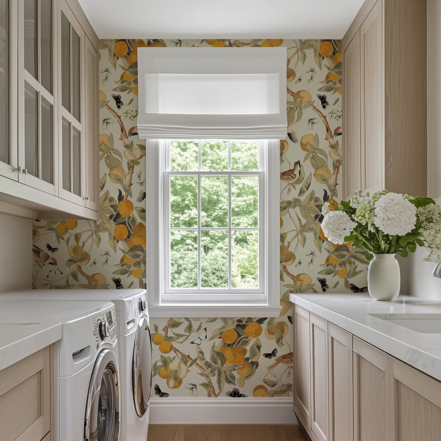 Laundry room with Vintage Citrus Wallpaper – Orange Tree, Birds & Butterflies, washer, dryer, and window.