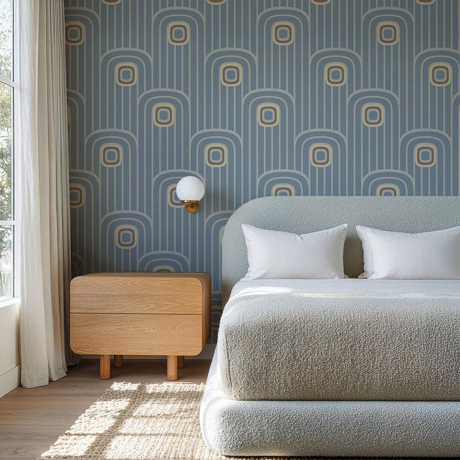 Modern bedroom with Dusty Blue 70s Retro Mod Arch Geometric Wallpaper wooden nightstand, and textured bedspread.