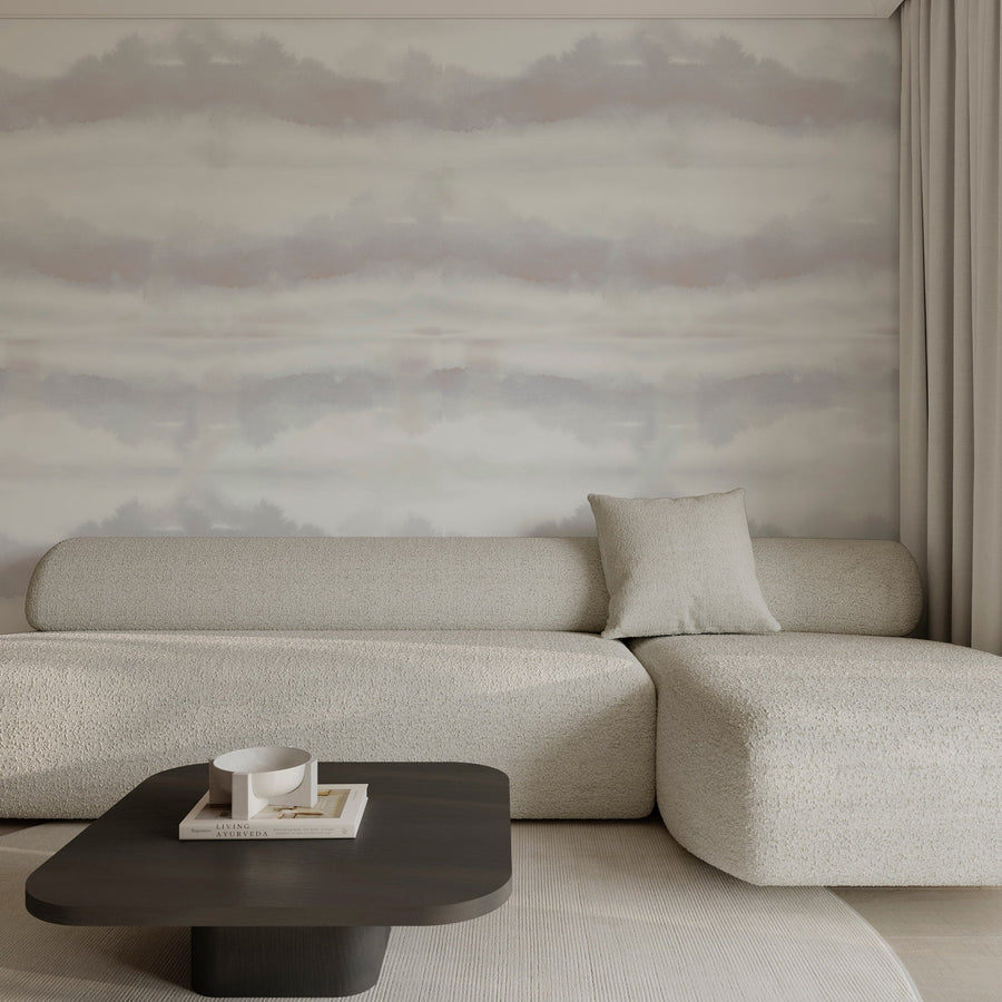 Modern living room with a beige sofa and a dark coffee table against a Grey Blush Watercolor Stripe Wallpaper