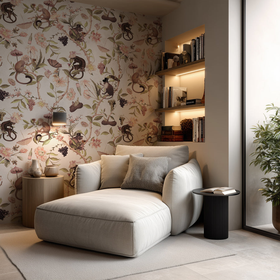 Modern living room with a white sofa, Blush Singerie Wallpaper – Romantic Monkey Garden, and decorative shelves.