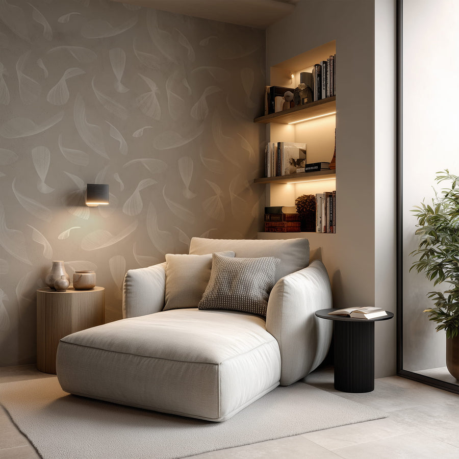 Modern living room with a white sofa, side table, and decorative wall shelves and  Quill Whispers Wallpaper – Warm Taupe