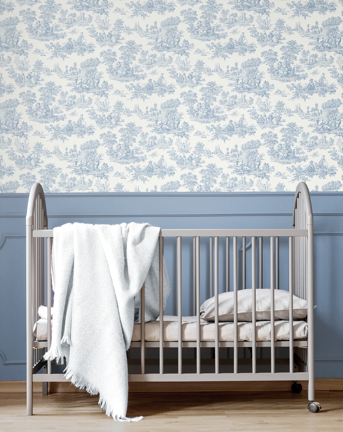 Nursery with a crib against a wall with blue floral wallpaper