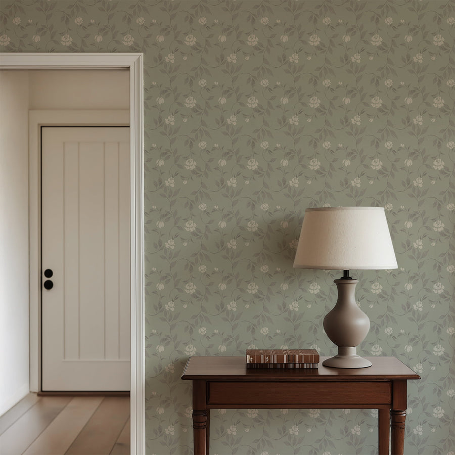Room interior with floral wallpaper, wooden table, and lamp.