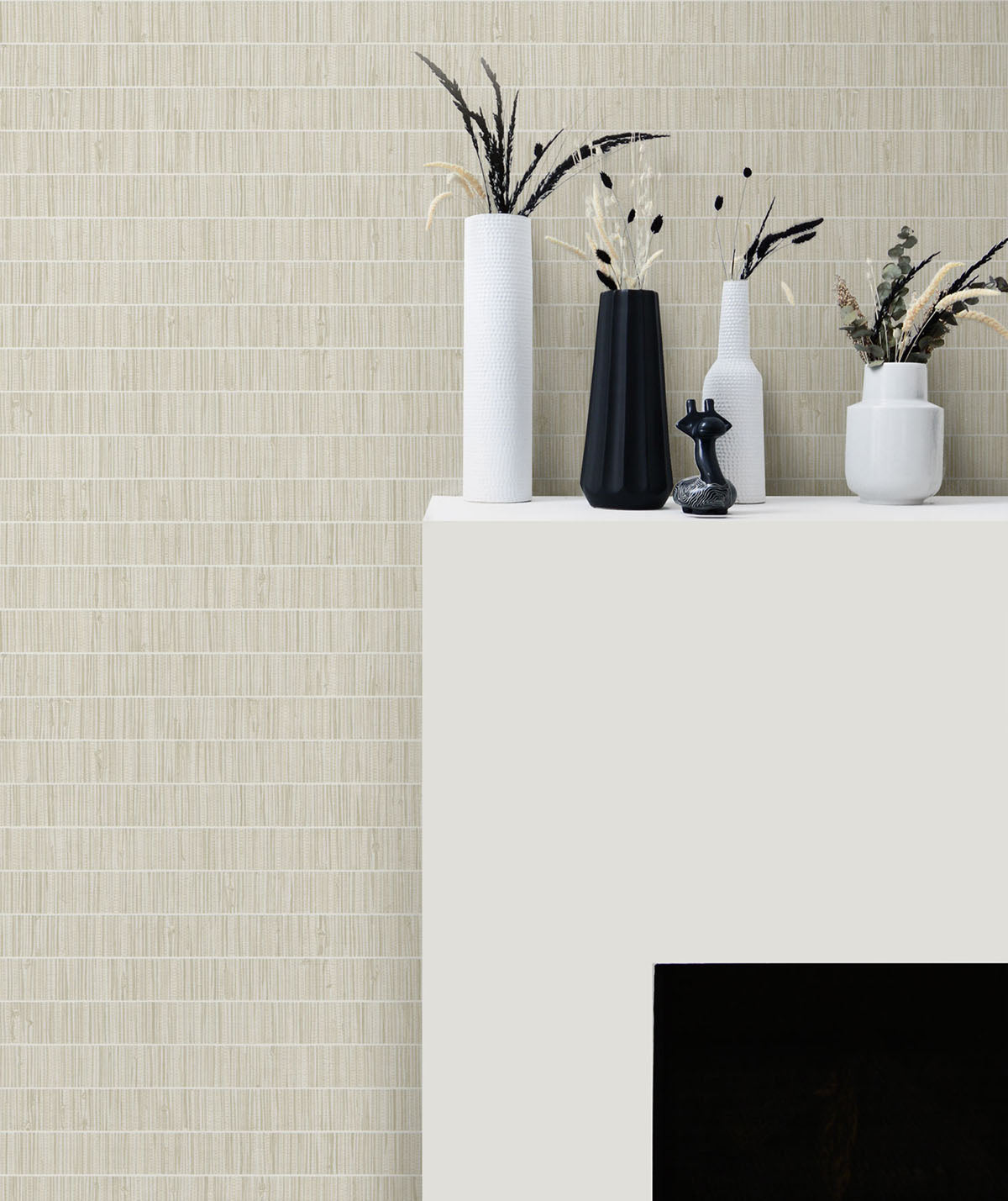 Decorative setup with vases and plants against a textured wall.