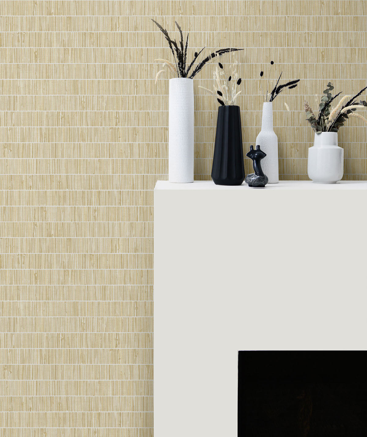 Decorative setup with vases and plants against a textured beige wall.