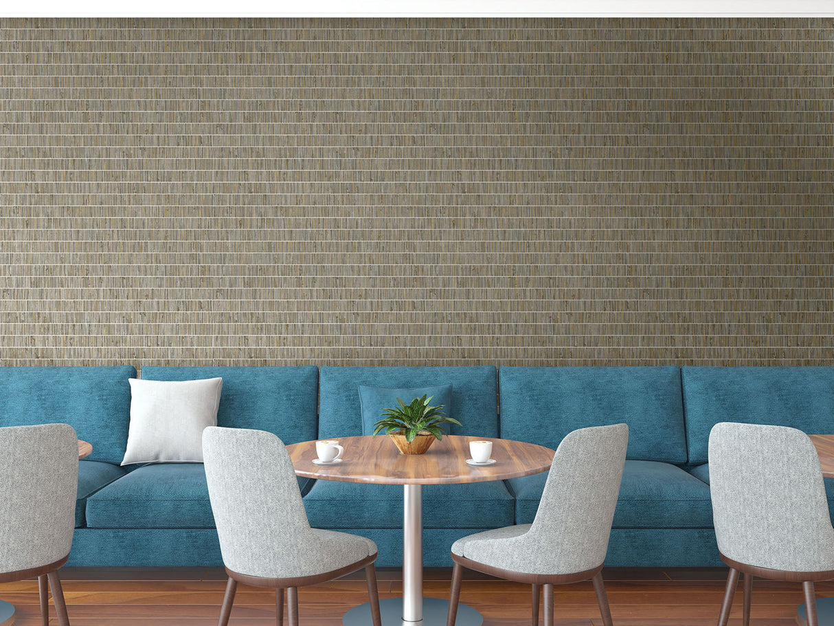 Modern interior with blue sofa, wooden table, and gray chairs against a textured wall.