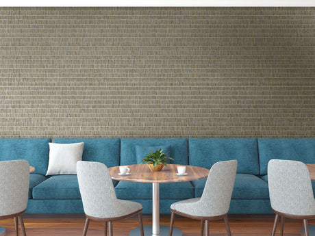 Modern interior with blue sofa, wooden table, and gray chairs against a textured wall.