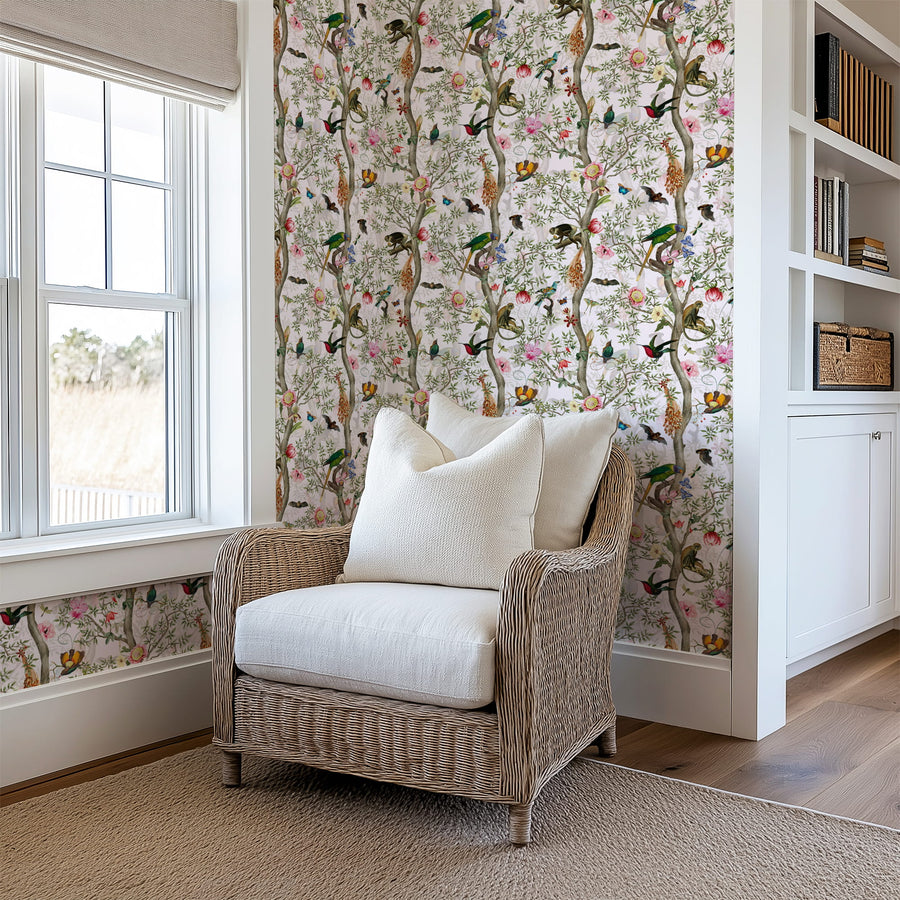 Wicker chair with white cushions in a room with Restaurant interior with Exotic Jungle Chinoiserie Wallpaper with Birds & Monkeys
