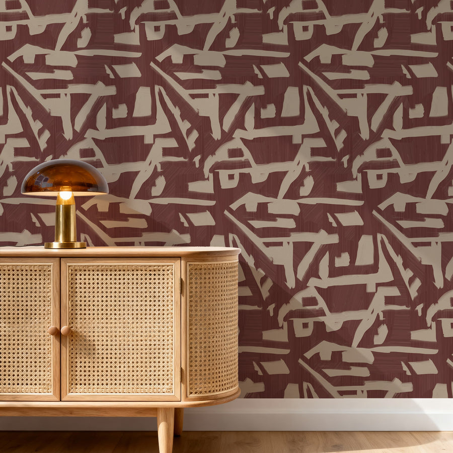 Entryway with rattan cane sideboard and amber dome lamp featuring Abstract Brushstroke Wallpaper Burgundy Taupe accent wall