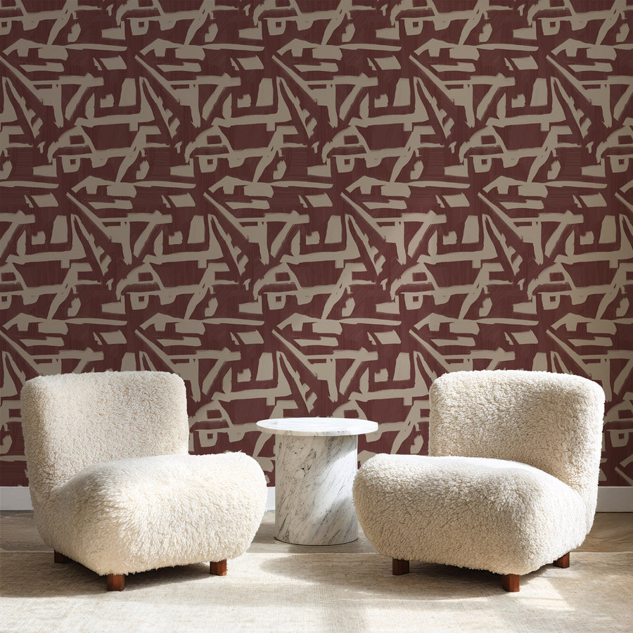 Lounge with cream shearling armchairs and white marble side table featuring Abstract Brushstroke Wallpaper Burgundy Taupe by Petra Kohlmayr