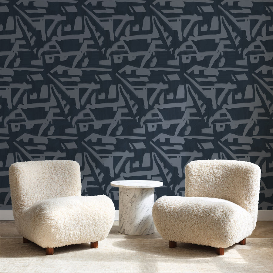 Lounge with cream boucle curved armchairs and side table featuring Abstract Brushstroke Wallpaper Navy Slate Blue accent wall