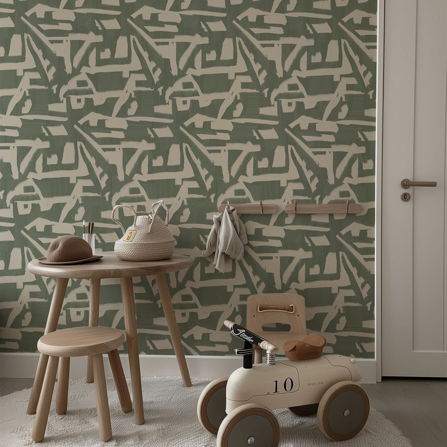 Dining nook with wood table chairs and kids play area featuring Abstract Brushstroke Wallpaper Sage Green Cream accent wall