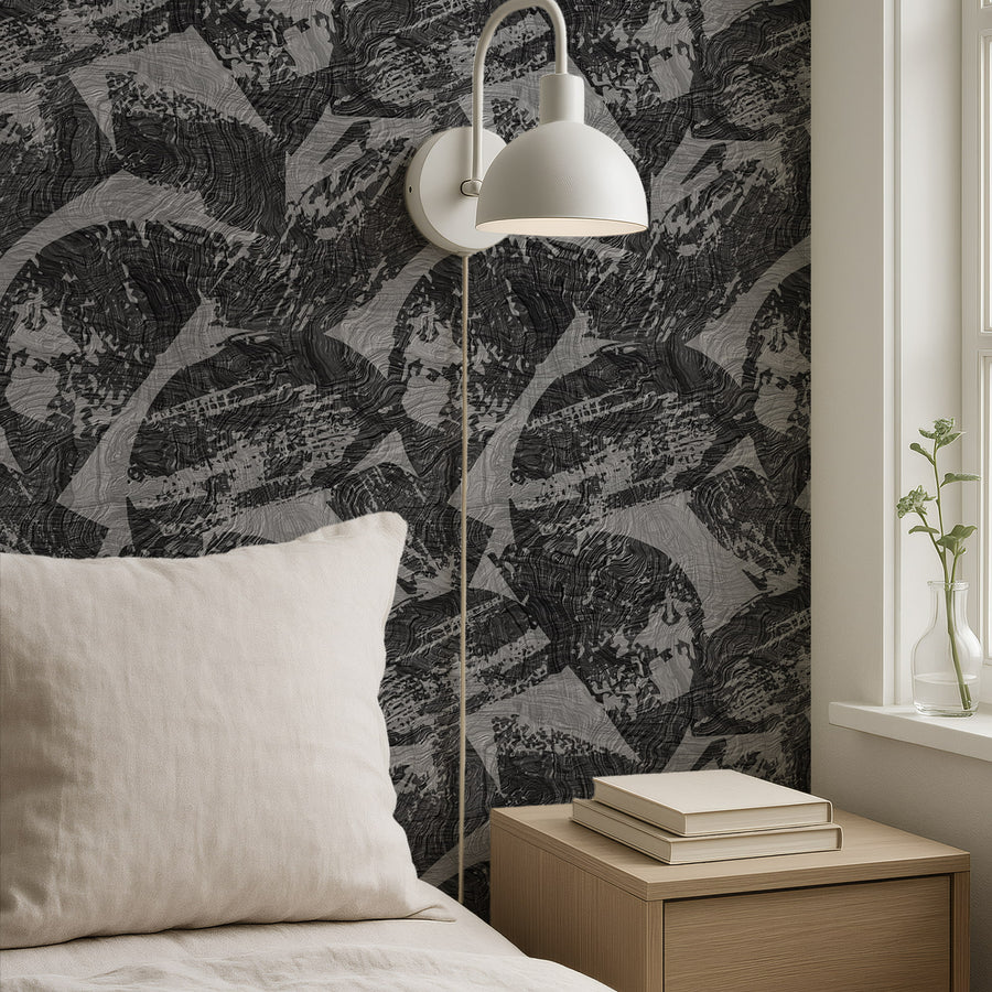 Bedroom with white bedding stacked books on nightstand and floor lamp featuring Abstract Modern Wood Texture Wallpaper Charcoal Grey by Petra Kohlmayr
