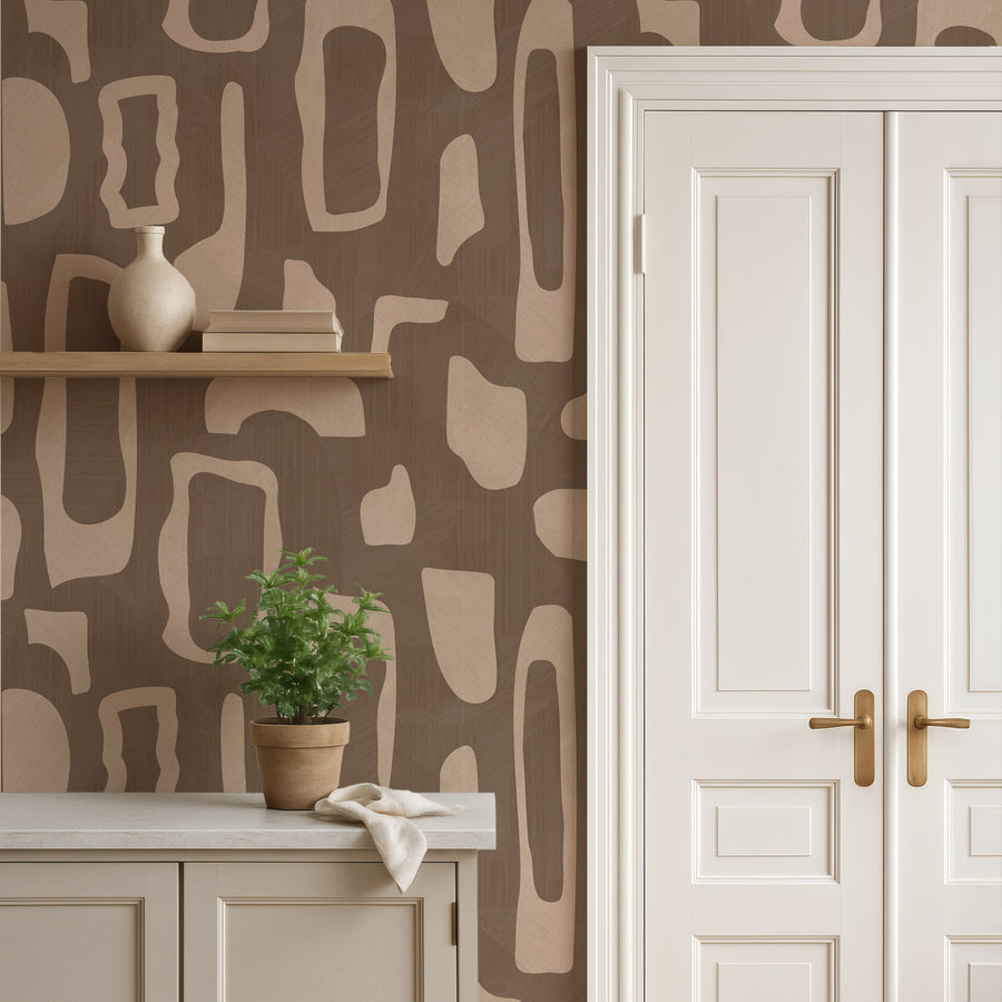 Console with potted plant and wall shelf beside white door featuring Abstract Organic Shapes Wallpaper Beige Brown accent wall