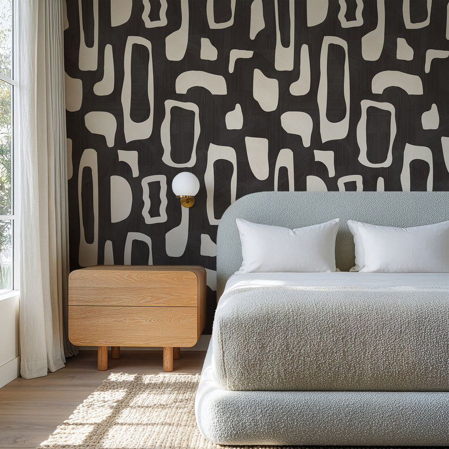 Bedroom with wood nightstand and white bedding featuring Abstract Organic Shapes Wallpaper Black Cream accent wall