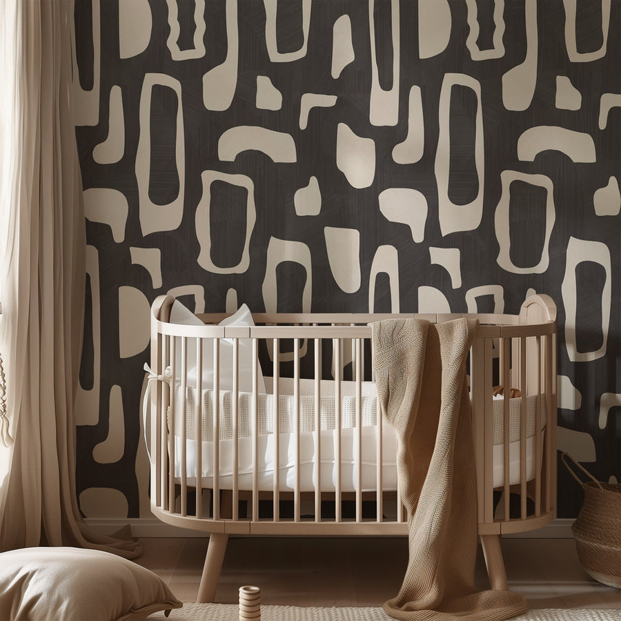 Nursery with wooden crib and draped throw featuring Abstract Organic Shapes Wallpaper Black Cream accent wall
