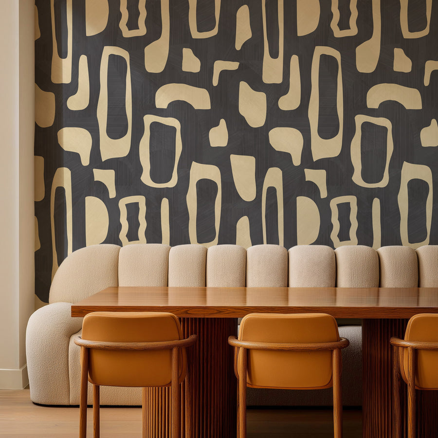 Dining room with banquette bench wood table and tan chairs featuring Abstract Organic Shapes Wallpaper Cream Charcoal by Petra Kohlmayr
