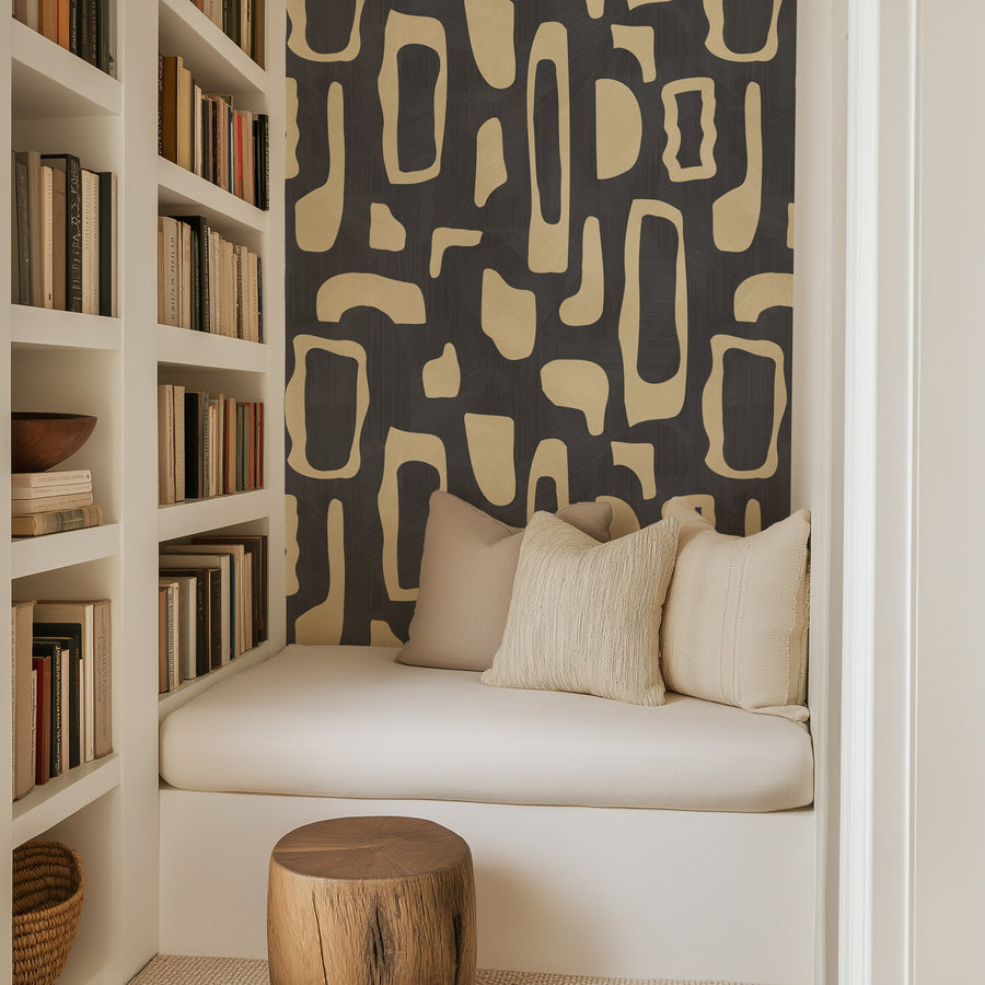 Reading nook with built-in shelves and cream seating featuring Abstract Organic Shapes Wallpaper Cream Charcoal accent wall