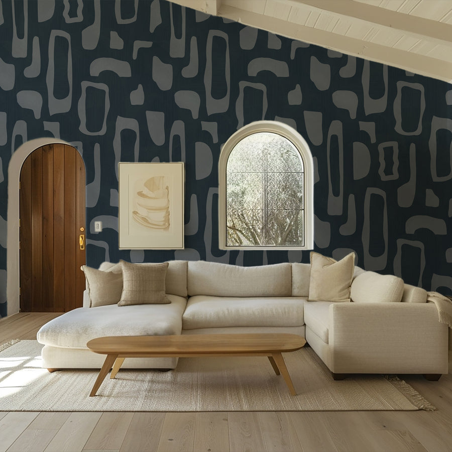 Living room with cream curved sofa wood coffee table and framed art featuring Abstract Organic Shapes Wallpaper Navy Slate Blue accent wall
