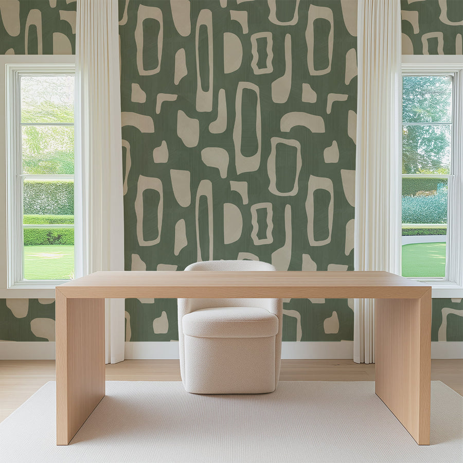 Dining room with wood table and cream curved chairs by a window featuring Abstract Organic Shapes Wallpaper Sage Green Beige accent wall