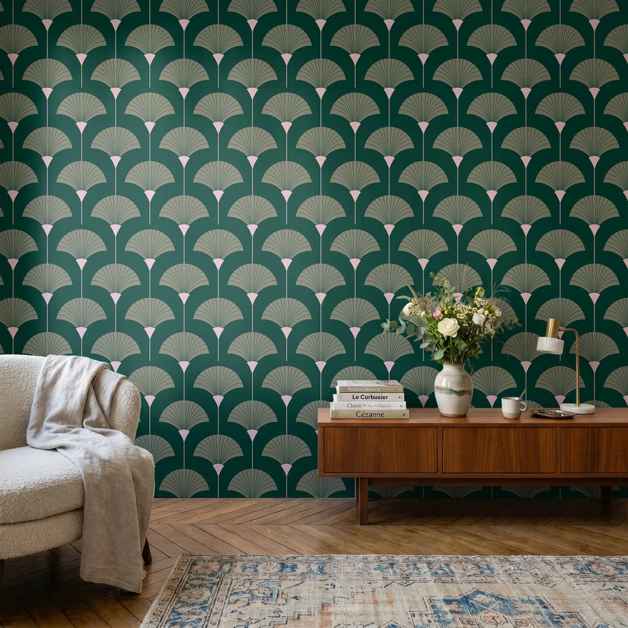 Forest and sage green Art Deco fan wallpaper in a living room with a walnut credenza and cream armchair