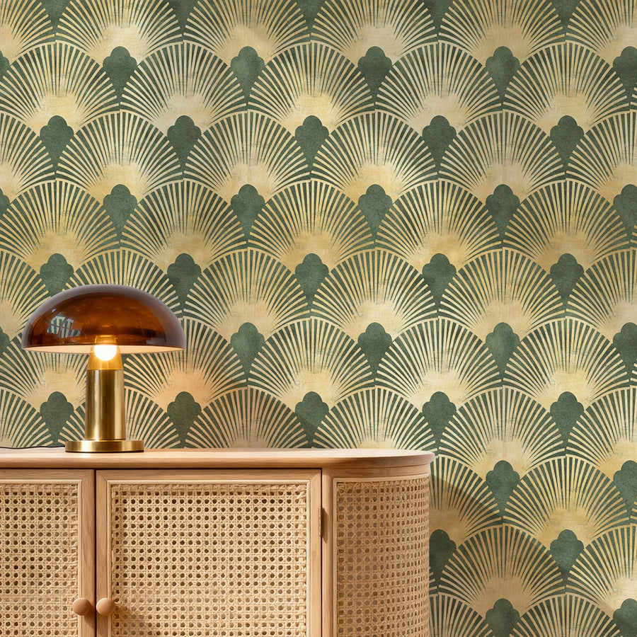 Green and gold Art Deco scallop wallpaper behind a cane sideboard with a gold mushroom lamp