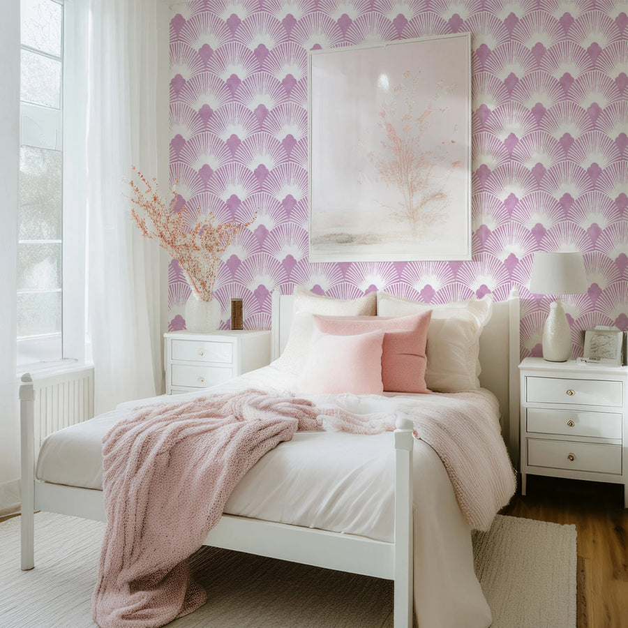 Pink mauve and white Art Deco scallop wallpaper in a bedroom with blush bedding and framed art