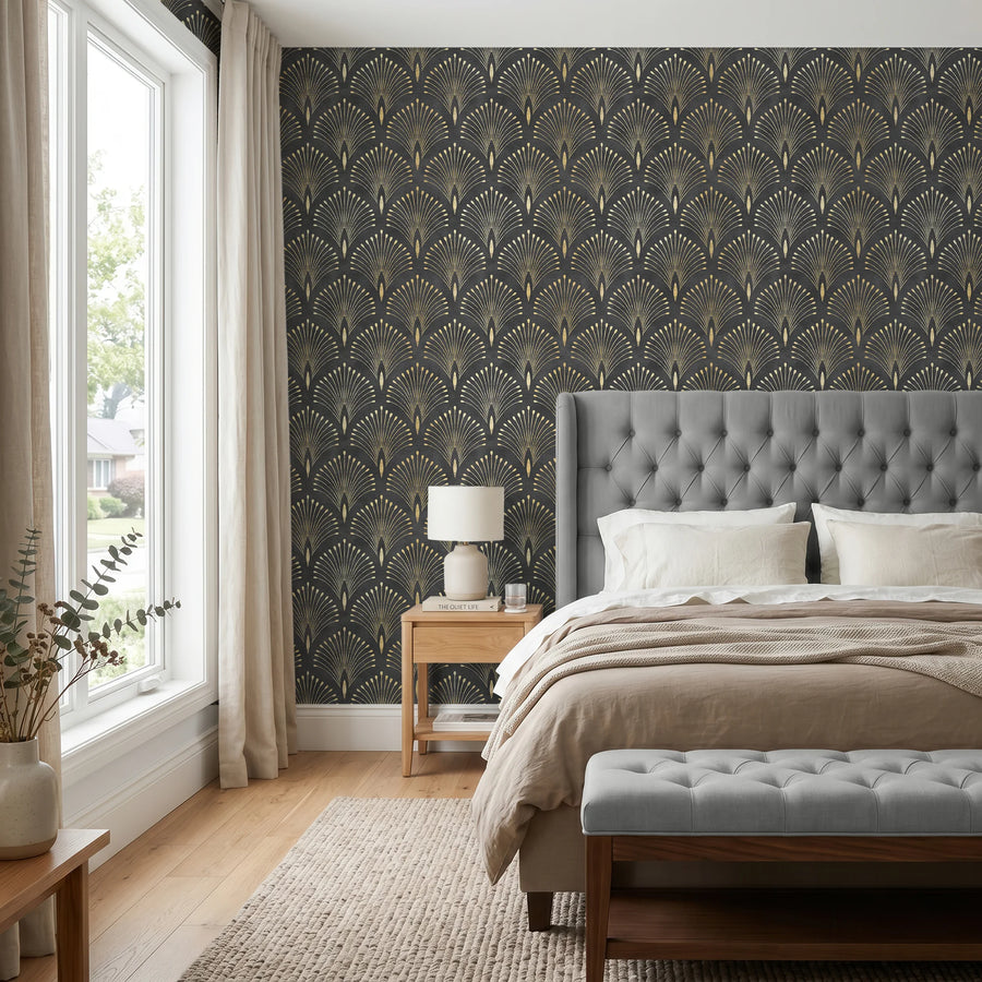 Art deco black and gold fan wallpaper in a bedroom with a tufted headboard