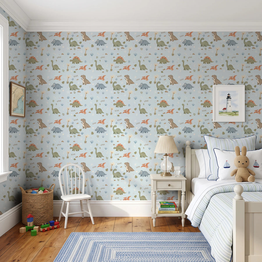 Cute powder blue dinosaur wallpaper in a child's bedroom with a bed, nightstand and white chair
