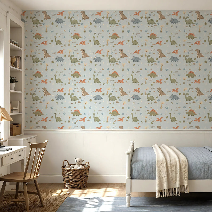 Baby dinosaur wallpaper in powder blue above white wainscoting in a kids bedroom with a desk