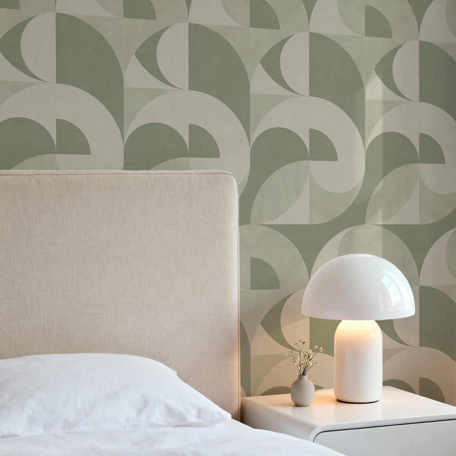 Bedroom with cream upholstered headboard and mushroom table lamp featuring Bauhaus Geometric Shapes Wallpaper Sage Green Cream by Petra Kohlmayr