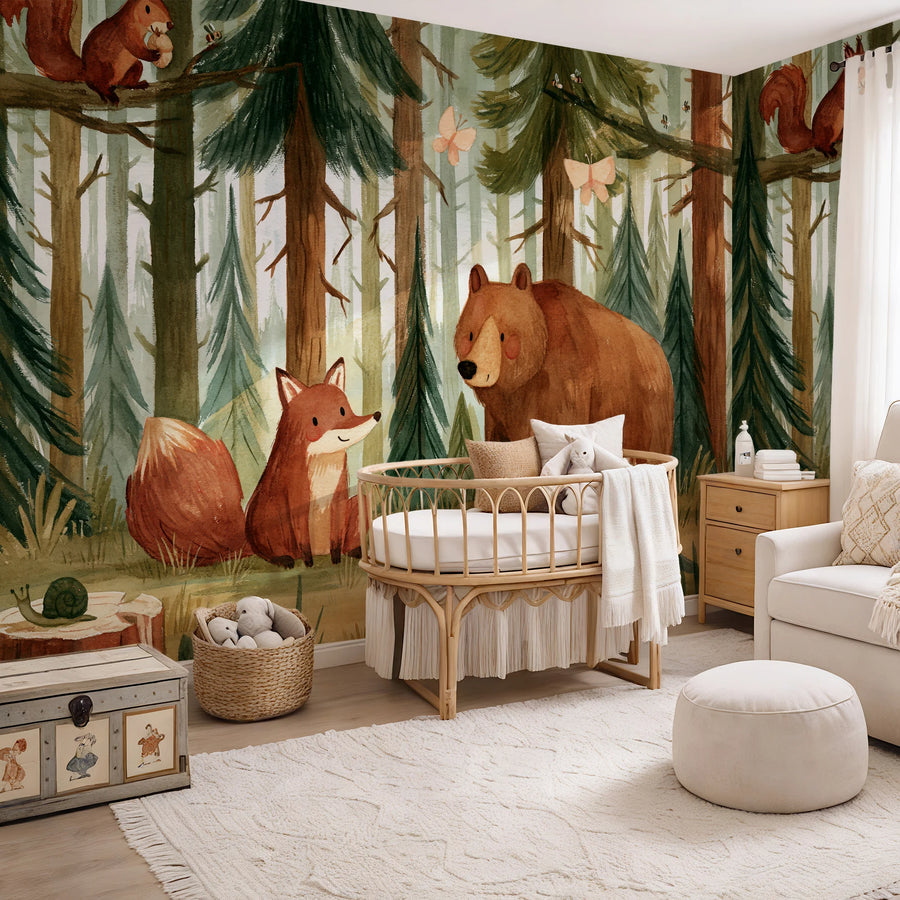 Bear and fox forest wallpaper mural for kids by Uta Naumann wrapping a nursery corner with a rattan bassinet and armchair