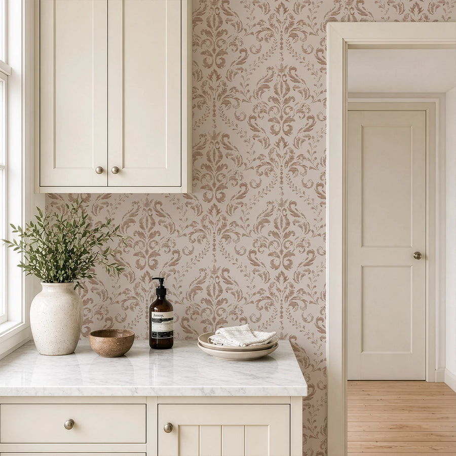 Beige distressed damask wallpaper in a laundry room with a stone counter