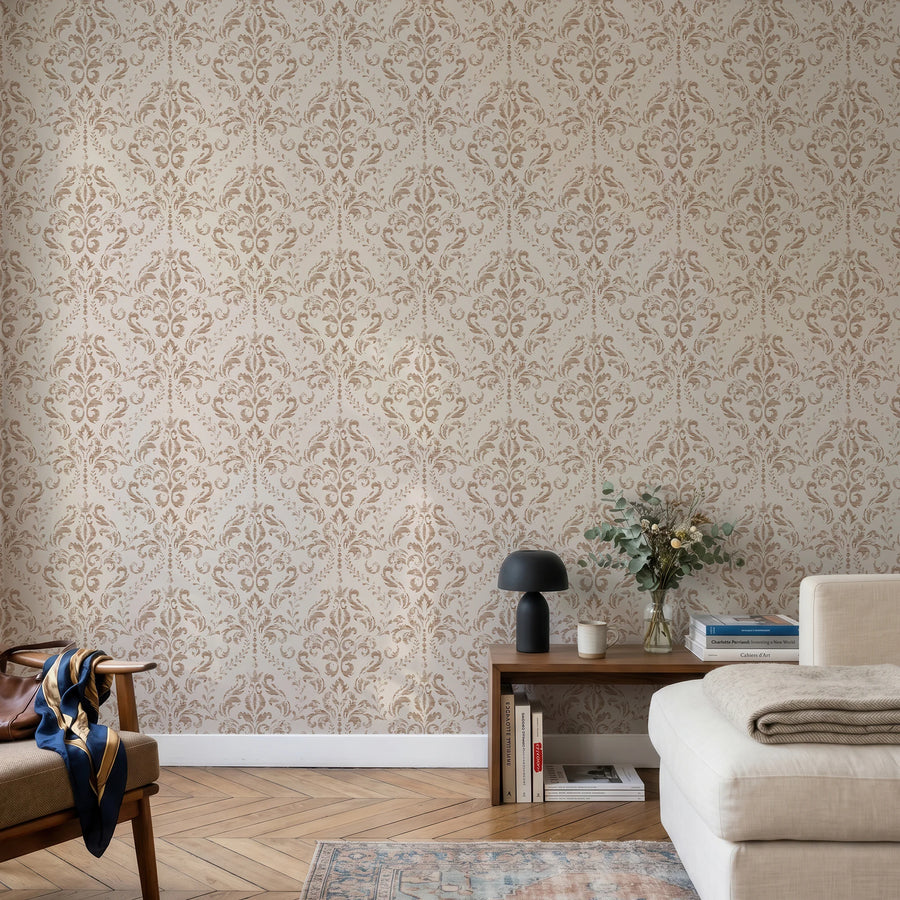 Beige distressed damask wallpaper in a living room with a neutral sofa and wood console
