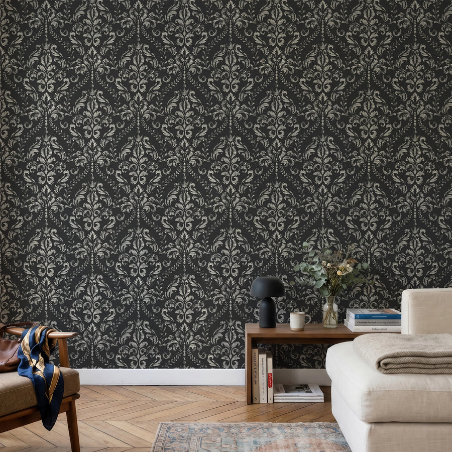 Black distressed damask wallpaper in a sitting room with a cream sofa