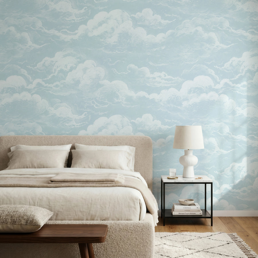 Blue sky and clouds wall mural in a calm bedroom with linen bedding