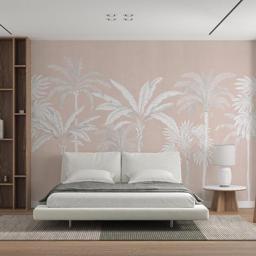 Blush pink palm tree mural in a sitting room behind a cream boucle armchair