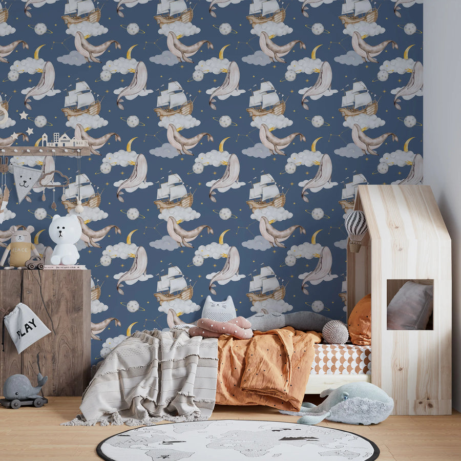 Navy celestial whale wallpaper in a kids room with a playhouse bed and round rug
