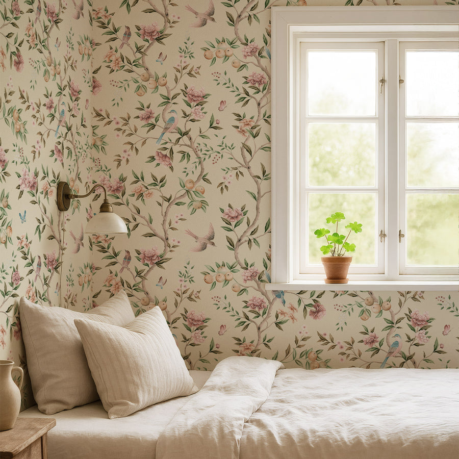 Bedroom with cream bedding and wall sconce by a window featuring Chinoiserie Floral Garden Bird Wallpaper Blush Cream accent wall