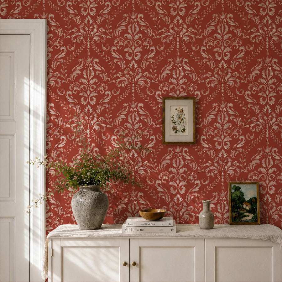Classic red damask wallpaper in a hallway behind a white dresser