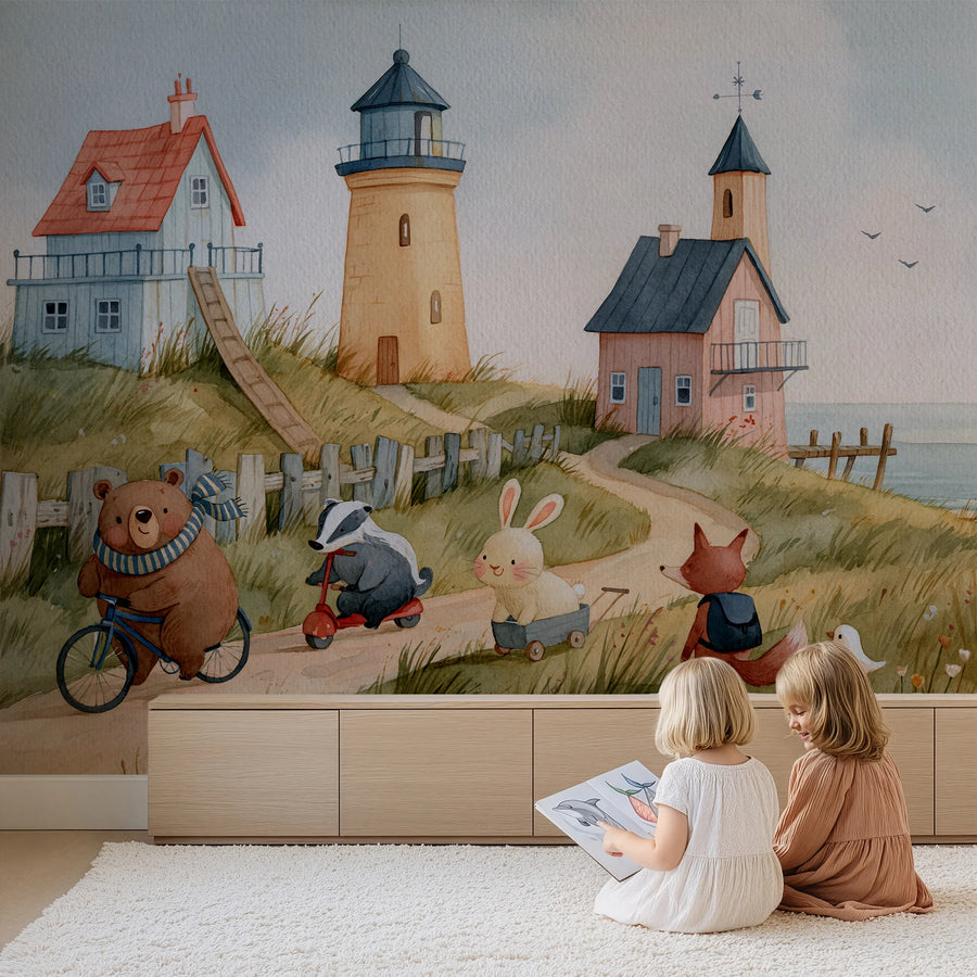 Coastal lighthouse and animals nursery wall mural by Uta Naumann behind two children reading in front of a low cabinet