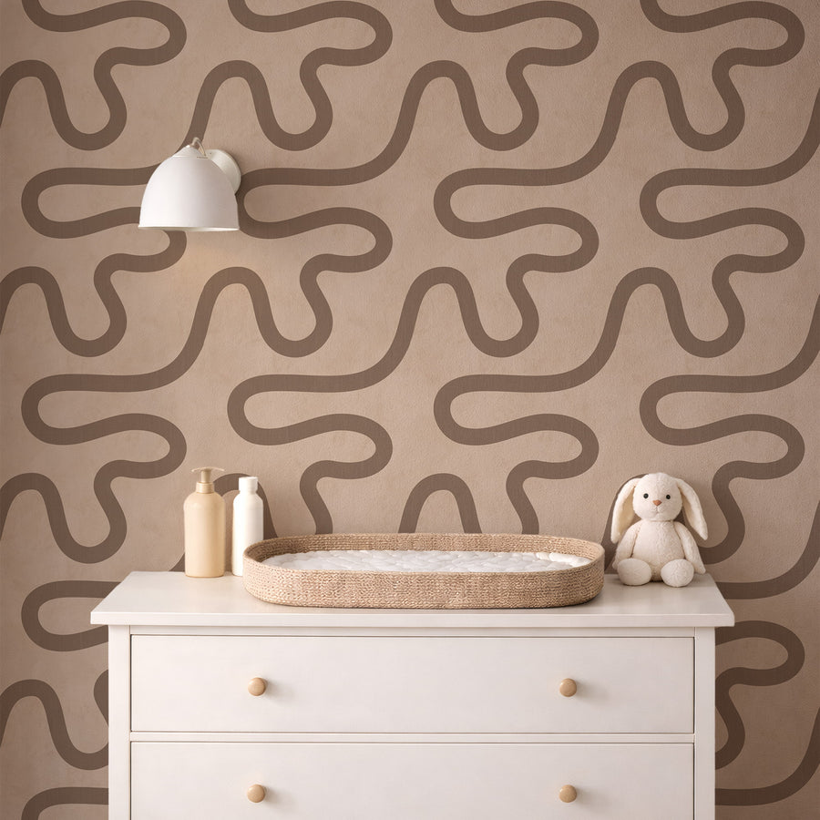 Close-up detail of Contemporary Meander Line Wallpaper showing flowing taupe line on sand textured ground
