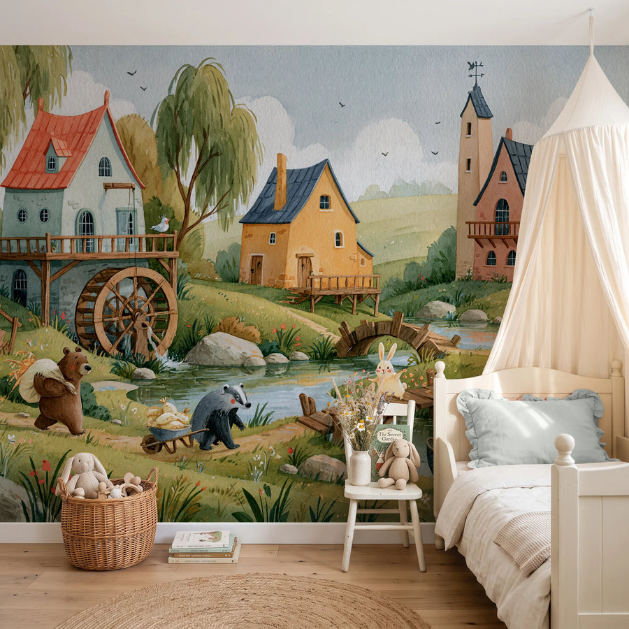 Countryside nursery wall mural by Uta Naumann with a watermill, cottages and woodland animals behind a canopy bed and child's chair