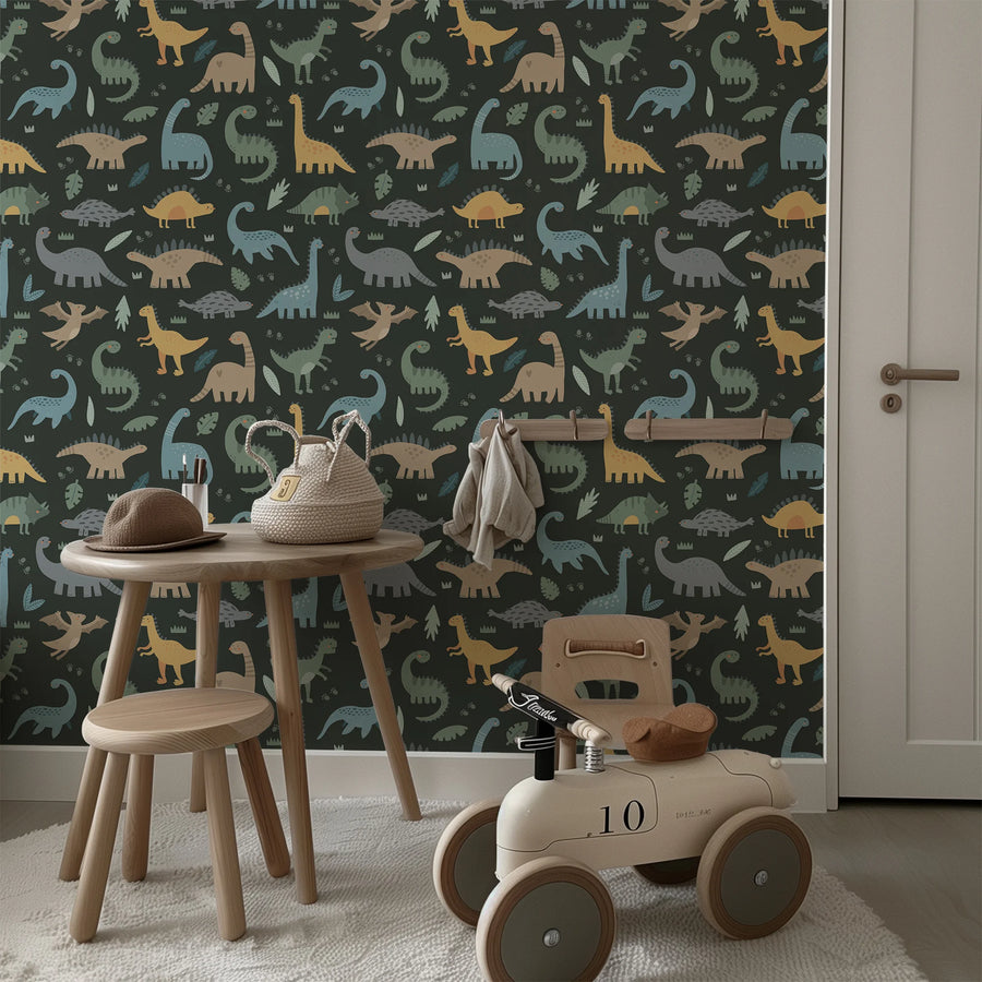 Dark green dinosaur wallpaper in a playroom with a small wooden table and toy car