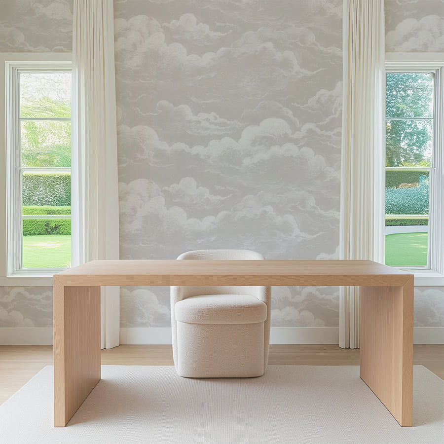 Dusty pink sky and clouds wall mural in a bright room with a desk